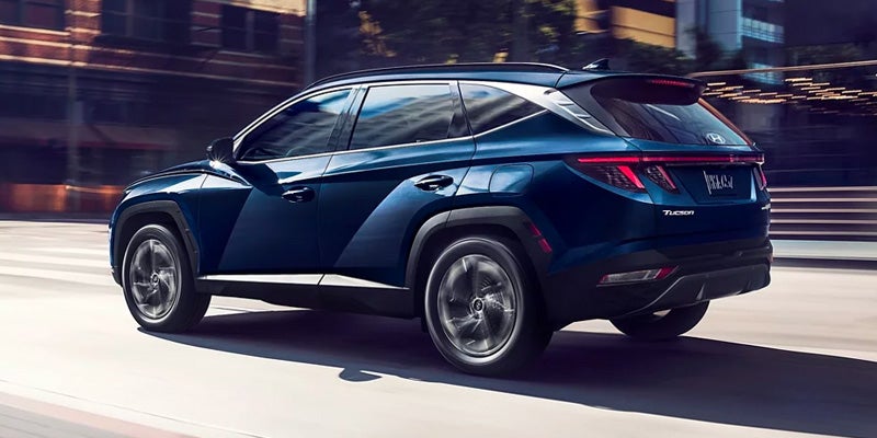 Hyundai driving along a bustling city street