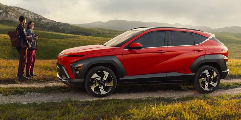 People stand outside 2025 Hyundai Kona