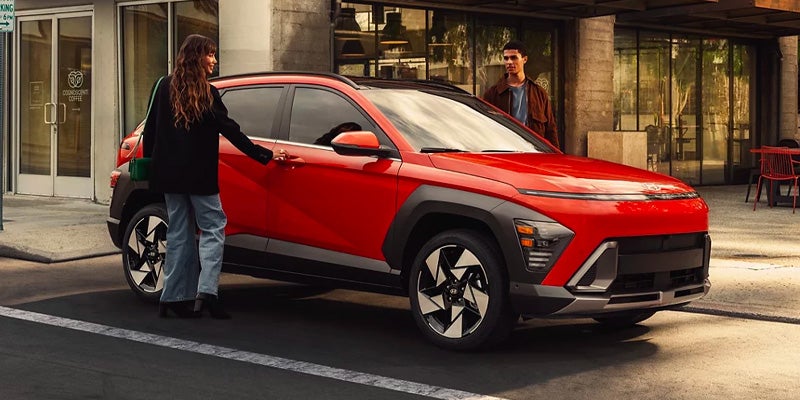 Girl opening door of 2025 Hyundai Kona